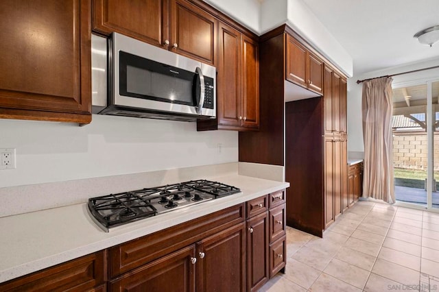 kitchen with stainless steel appliances and light tile patterned floors