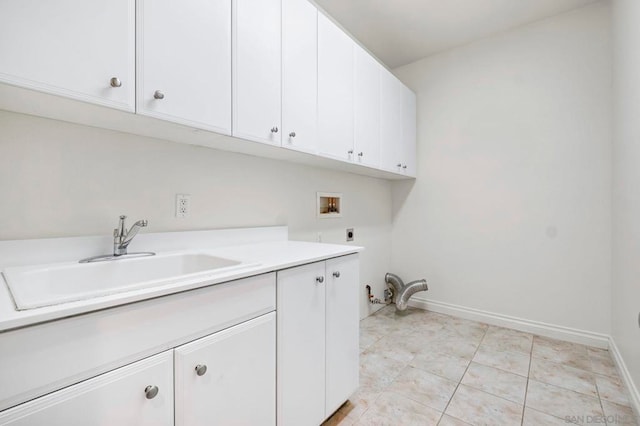 laundry room with sink, electric dryer hookup, hookup for a washing machine, cabinets, and light tile patterned flooring