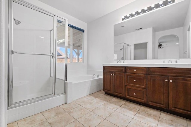 bathroom featuring ceiling fan, tile patterned flooring, vanity, and shower with separate bathtub