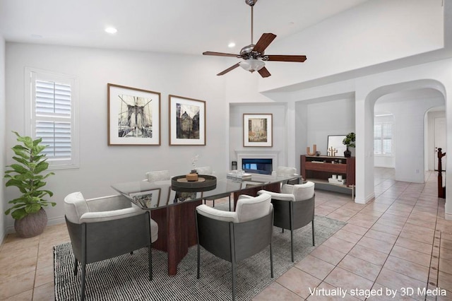 tiled dining room featuring ceiling fan and lofted ceiling