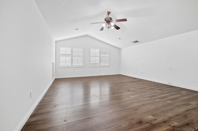 spare room with lofted ceiling, ceiling fan, and dark hardwood / wood-style floors