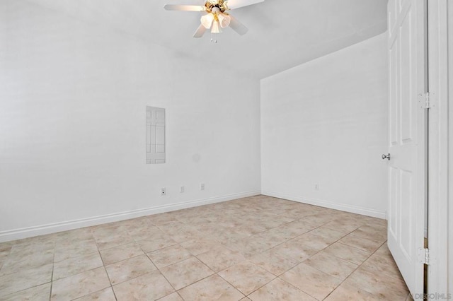 tiled empty room featuring ceiling fan