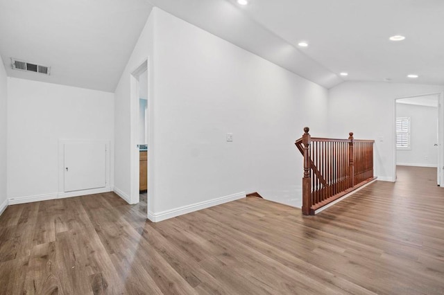 interior space with light wood-type flooring and vaulted ceiling