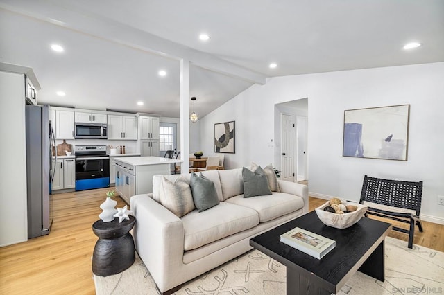 living room with light wood-type flooring and vaulted ceiling with beams