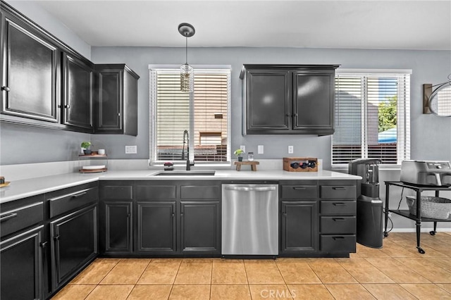 kitchen featuring decorative light fixtures, dishwasher, light tile patterned floors, and sink