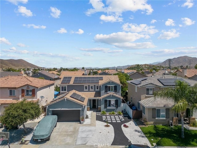 view of front of property featuring a garage and a mountain view