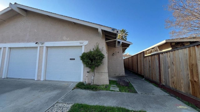 view of side of home featuring a garage and an outdoor structure