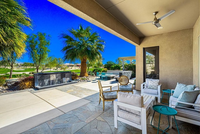 view of patio / terrace featuring an outdoor living space, a bar, and ceiling fan