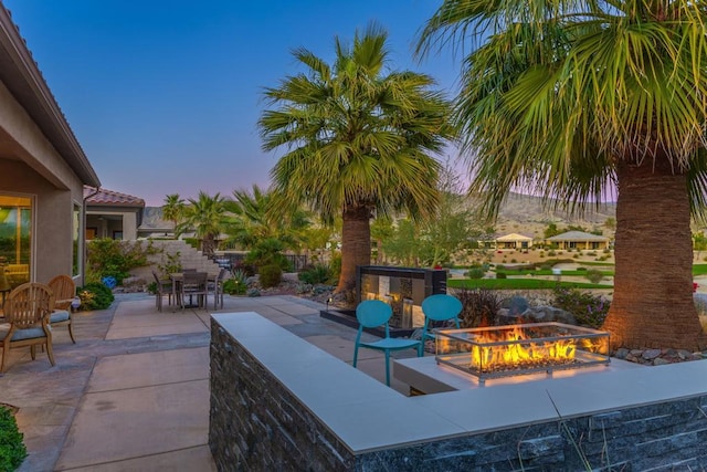 patio terrace at dusk with a fire pit