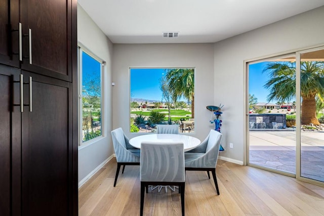 dining space featuring light wood-type flooring