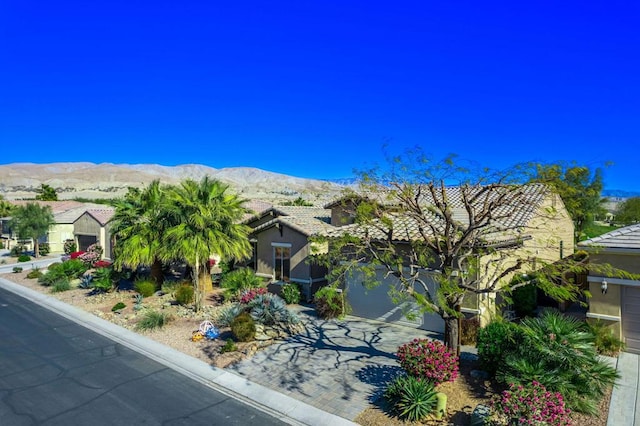 view of front of house with a mountain view and a garage