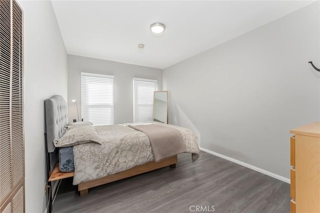 bedroom with dark hardwood / wood-style flooring