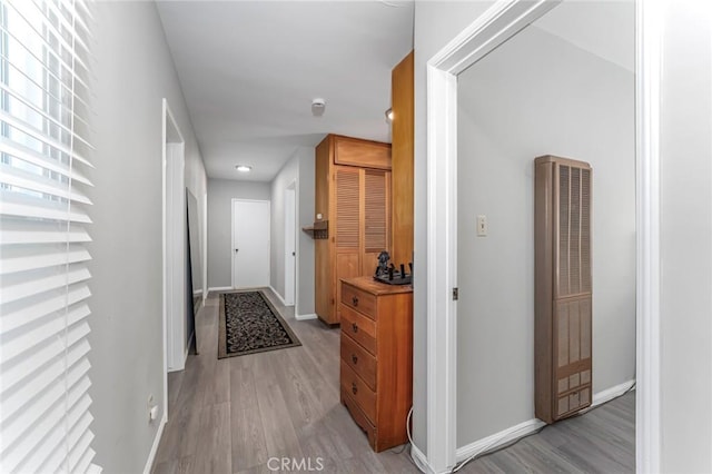 corridor with light hardwood / wood-style floors