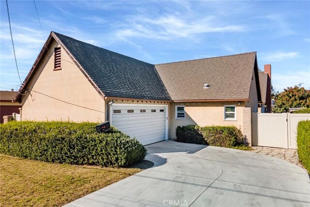 view of side of property with a lawn and a garage