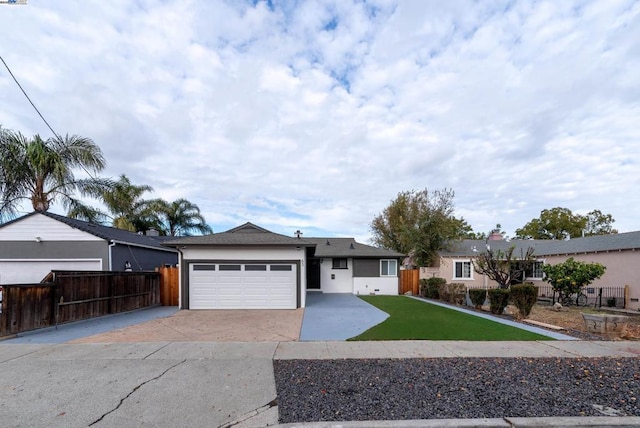 ranch-style house featuring a front yard and a garage