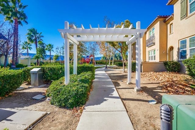 view of property's community featuring a pergola and a playground