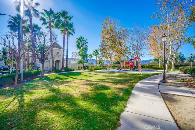 surrounding community featuring a yard and a playground