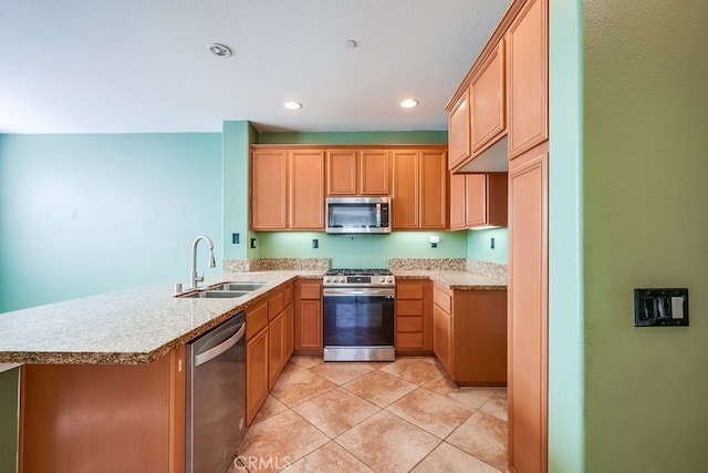 kitchen featuring stainless steel appliances, kitchen peninsula, light tile patterned floors, light stone counters, and sink