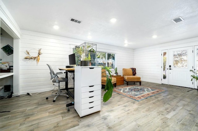 office with wooden walls and hardwood / wood-style floors