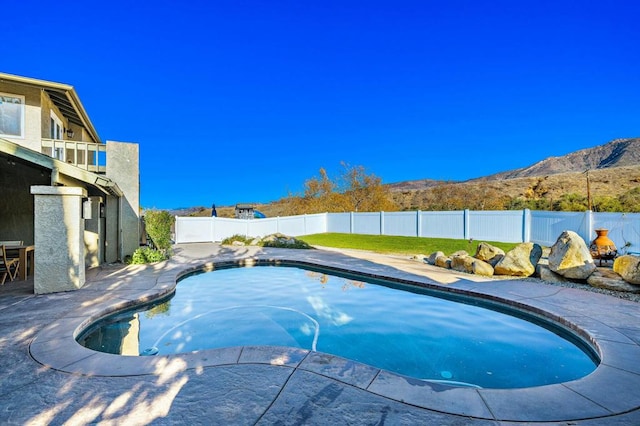 view of pool with a mountain view and a patio area