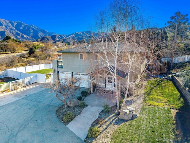 exterior space with a garage and a mountain view