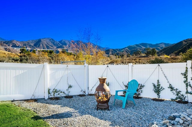 view of yard featuring a fire pit and a mountain view