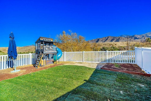 view of yard with a playground and a mountain view