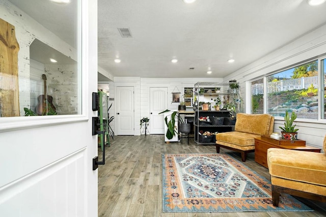 living area with hardwood / wood-style flooring