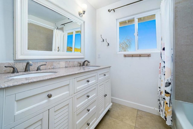 bathroom with vanity, tile patterned floors, and shower / bath combo with shower curtain