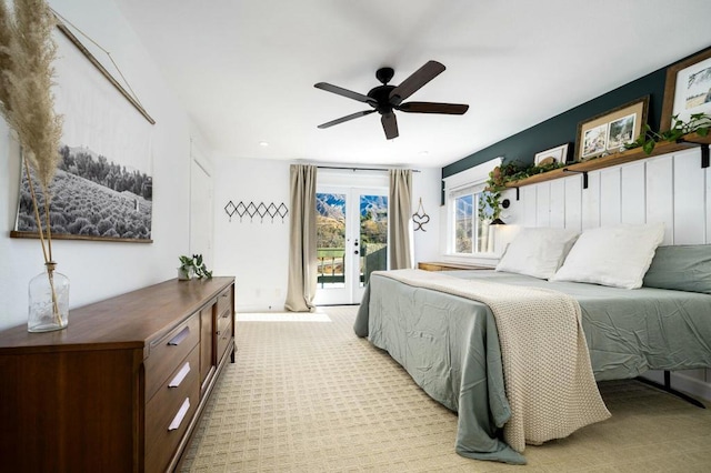 bedroom featuring access to outside, light colored carpet, french doors, and ceiling fan