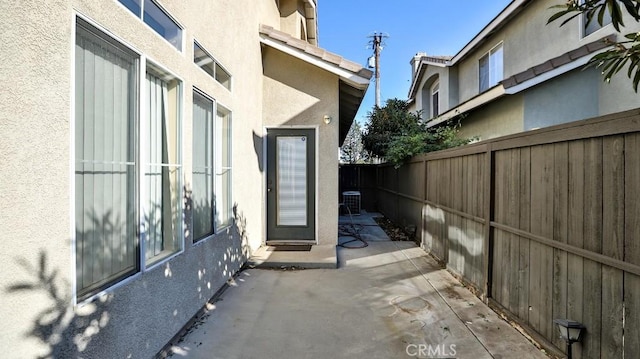 view of property exterior featuring cooling unit and a patio area