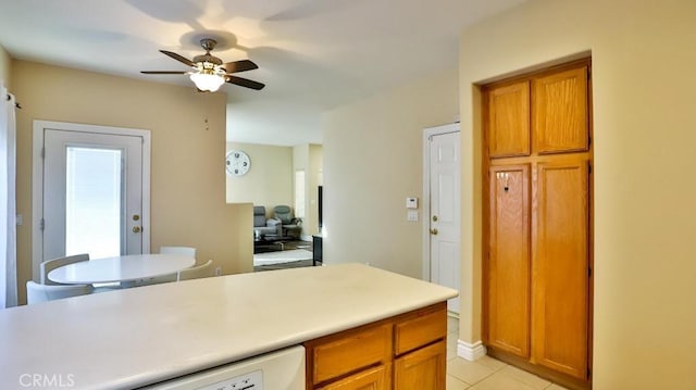 kitchen featuring ceiling fan, light tile patterned floors, and white dishwasher