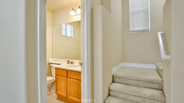 bathroom featuring toilet and vanity