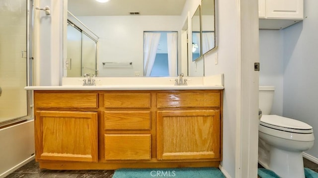 full bathroom with toilet, combined bath / shower with glass door, and vanity