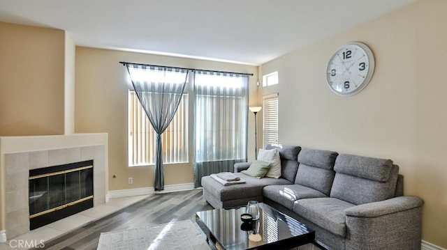 living room with hardwood / wood-style flooring and a tile fireplace