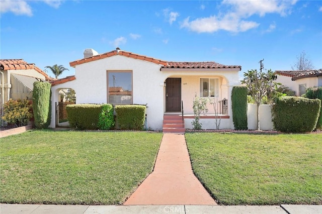 mediterranean / spanish-style house featuring a front yard