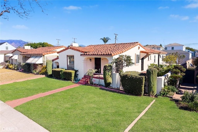 mediterranean / spanish home featuring a front yard