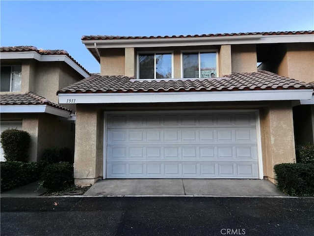 1911 E Calico Dr, West Covina, CA 91791 - view of front facade with a tiled roof, stucco siding, and a garage