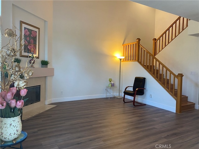 1911 E Calico Dr, West Covina, CA 91791 - unfurnished room featuring wood finished floors, stairs, baseboards, and a tiled fireplace