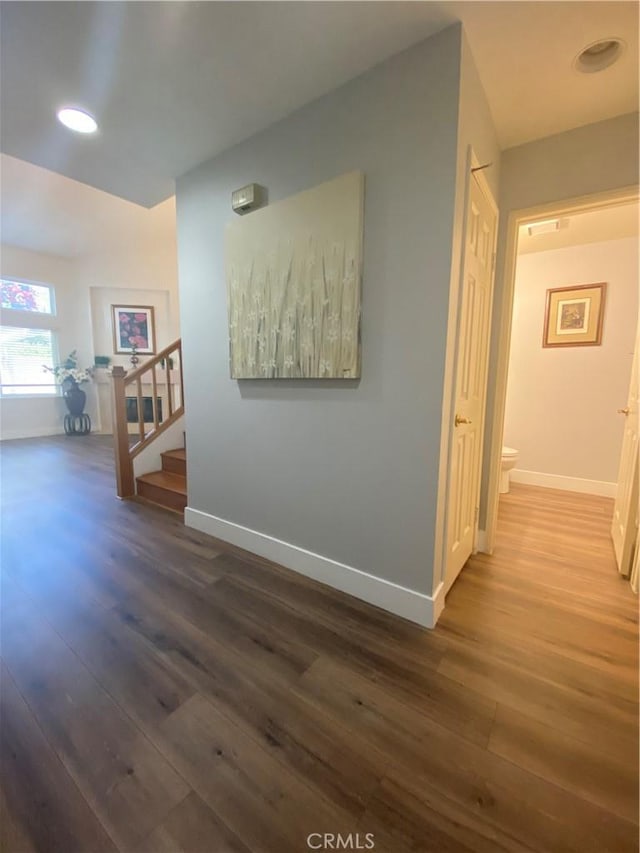 1911 E Calico Dr, West Covina, CA 91791 - corridor with wood finished floors, stairway, and baseboards