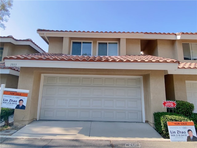 1911 E Calico Dr, West Covina, CA 91791 - multi unit property with stucco siding, concrete driveway, a tiled roof, and an attached garage