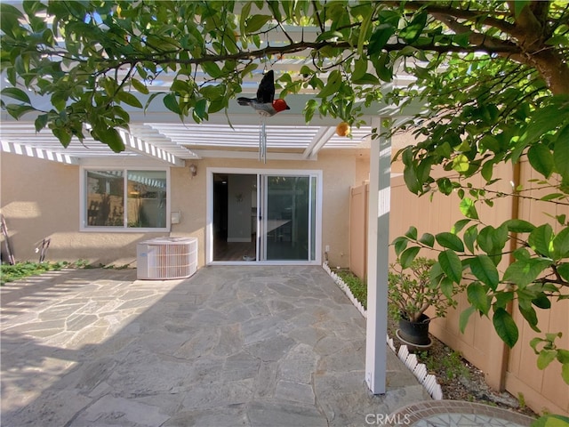 1911 E Calico Dr, West Covina, CA 91791 - doorway to property featuring cooling unit, a pergola, stucco siding, and a patio area