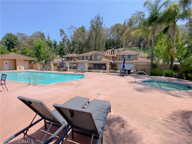 1911 E Calico Dr, West Covina, CA 91791 - community pool with a community hot tub, a patio, and view of wooded area
