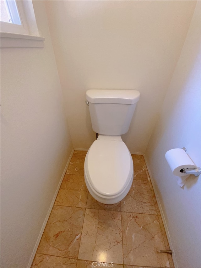 1911 E Calico Dr, West Covina, CA 91791 - bathroom with marble look tiles, toilet, and baseboards