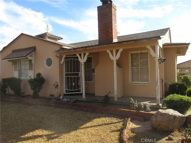 rear view of property featuring a yard and a patio