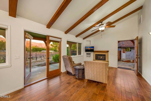 living room with ceiling fan, high vaulted ceiling, beamed ceiling, and hardwood / wood-style flooring