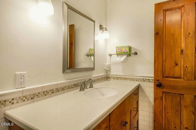 bathroom featuring vanity and tile walls