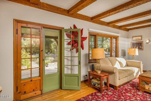 doorway featuring light hardwood / wood-style floors and beamed ceiling