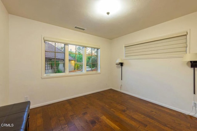 unfurnished room featuring dark hardwood / wood-style flooring