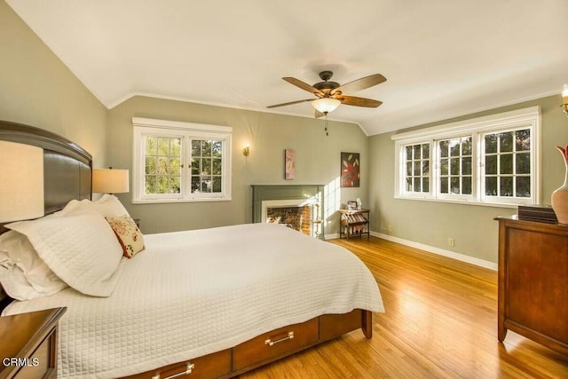 bedroom featuring lofted ceiling, light wood-type flooring, and ceiling fan